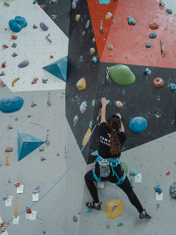 Woman doing indoor rock climbing.