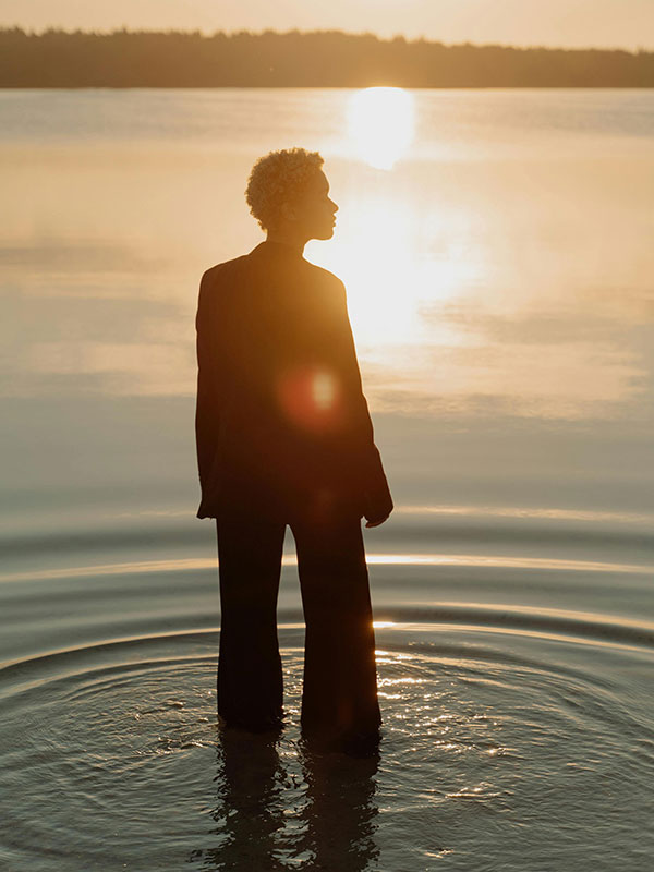 Silhouette of a woman standing in the sea.
