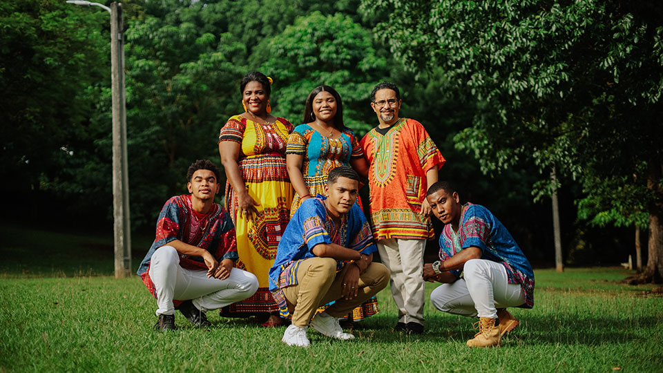 Group of ethnic people in traditional clothes posing and smiling.