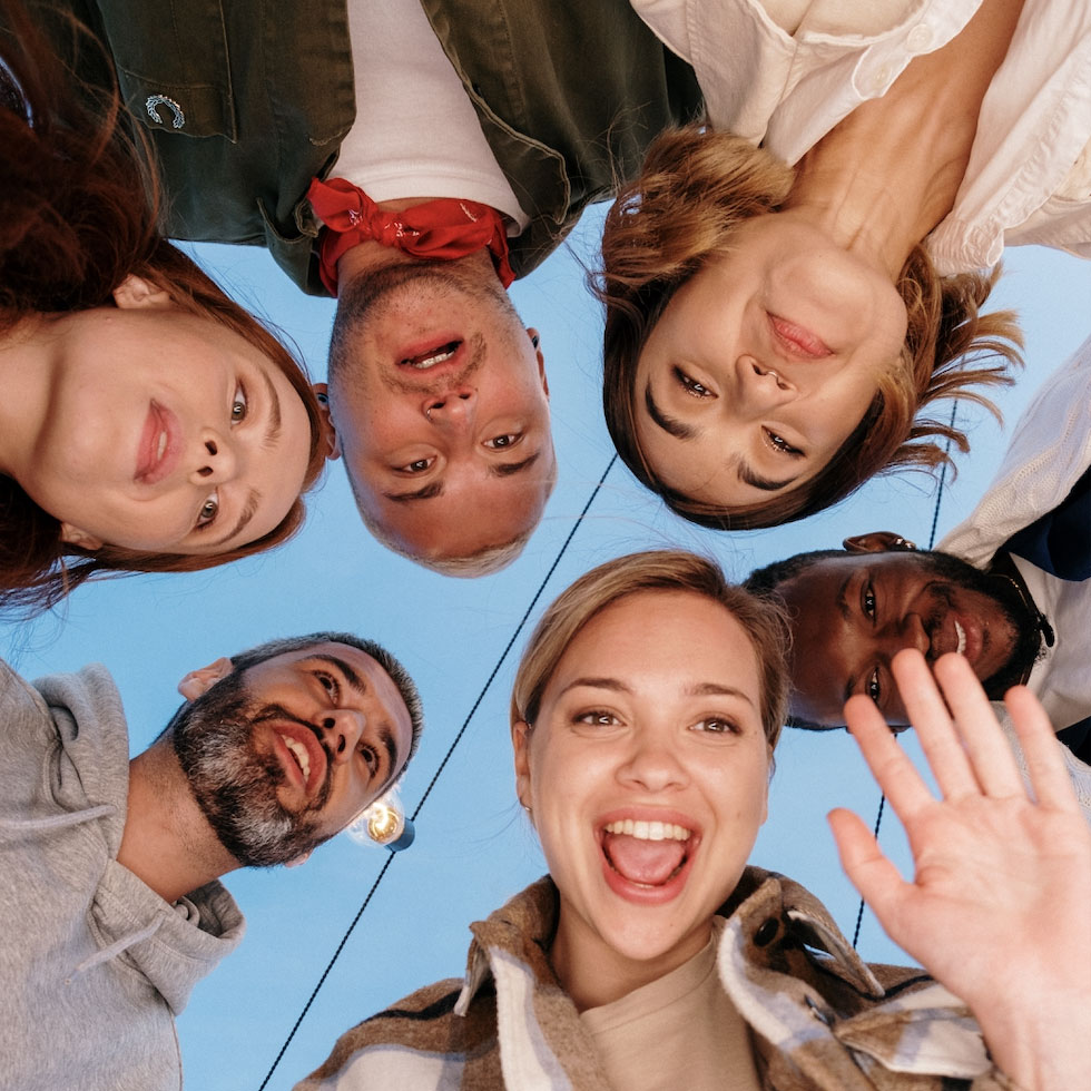 Looking up at a group of people in a huddle